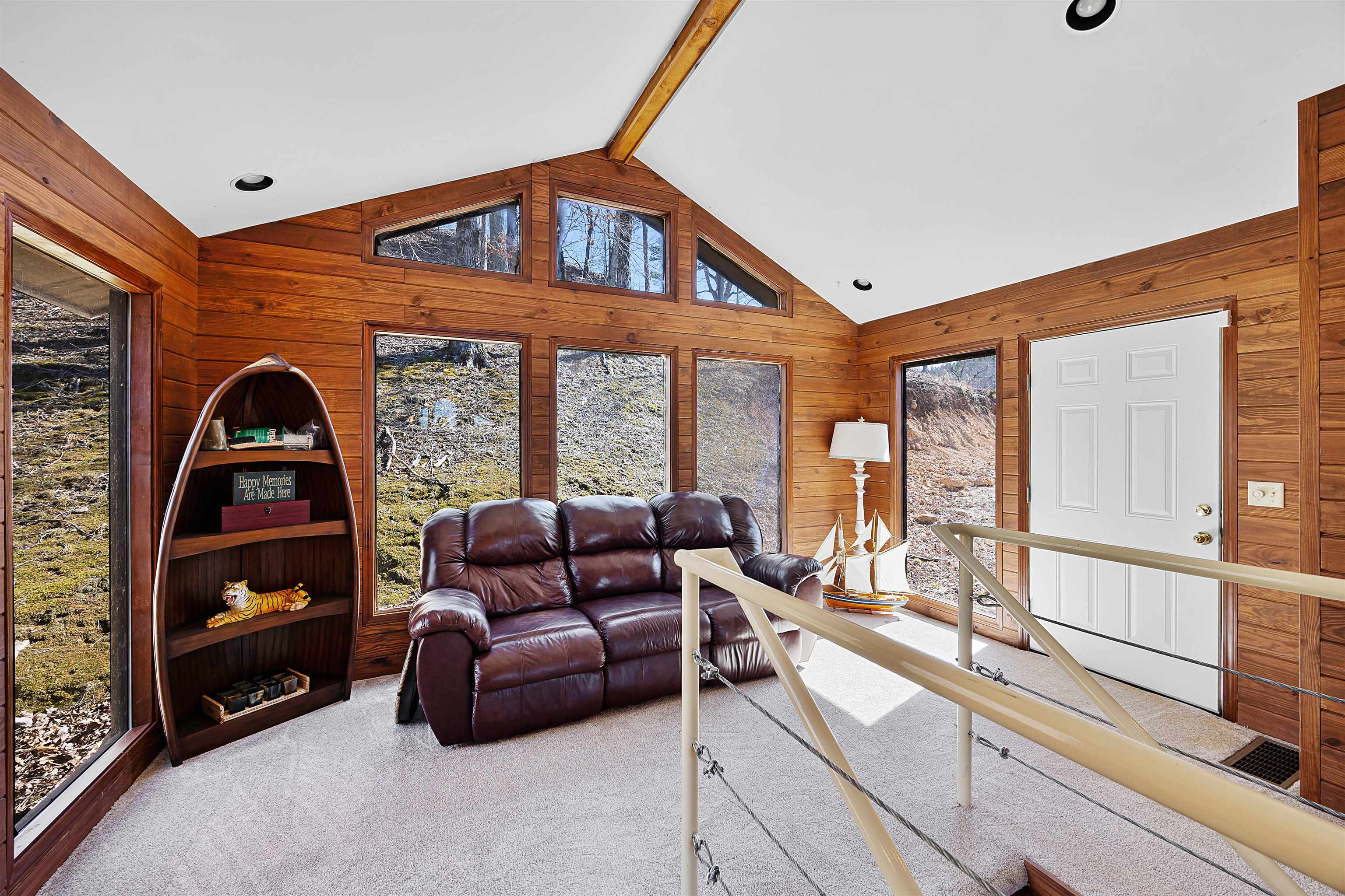 228 Chickasaw Trace Cherokee, AL 35616 - Photo 12 of 27 Carpeted living area featuring wooden walls, high vaulted ceiling, and beam ceiling