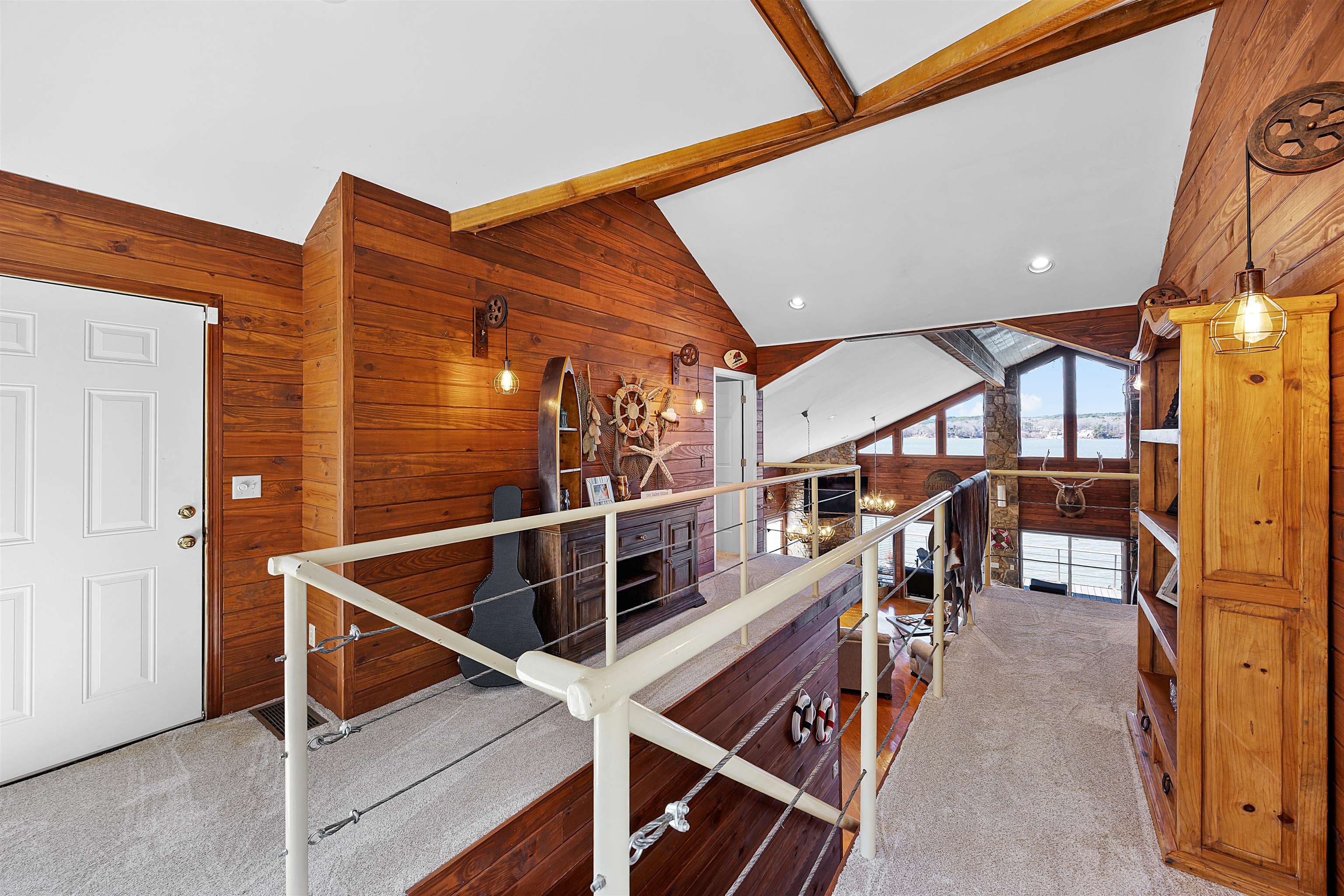 228 Chickasaw Trace Cherokee, AL 35616 - Photo 13 of 27 Interior space featuring lofted ceiling with beams, wood walls, and carpet floors