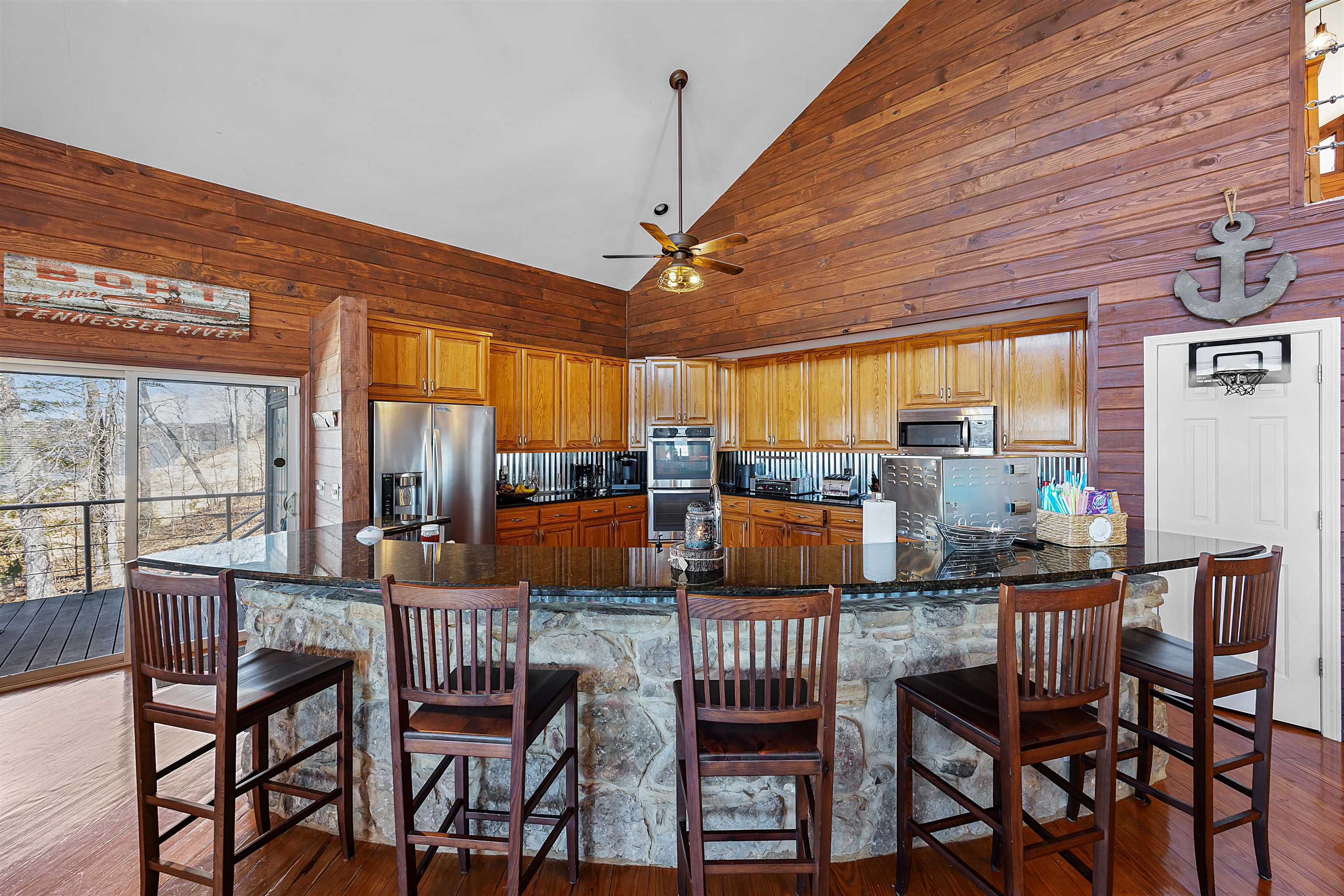 228 Chickasaw Trace Cherokee, AL 35616 - Photo 3 of 27 Kitchen featuring high vaulted ceiling, stainless steel appliances, a ceiling fan, dark wood-style floors, and dark stone countertops