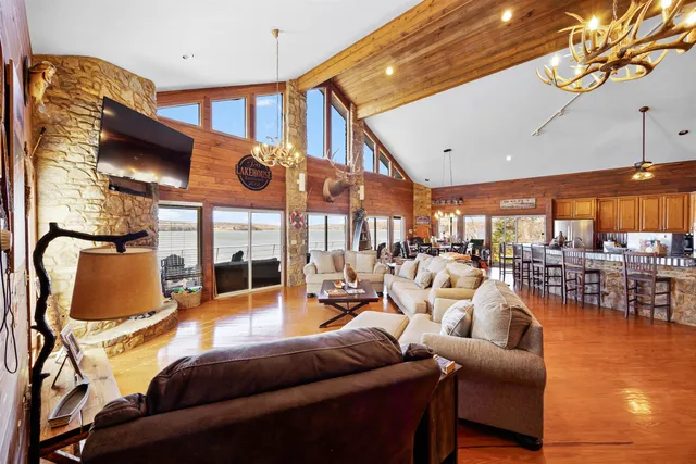 a living room with furniture a large window and a chandelier