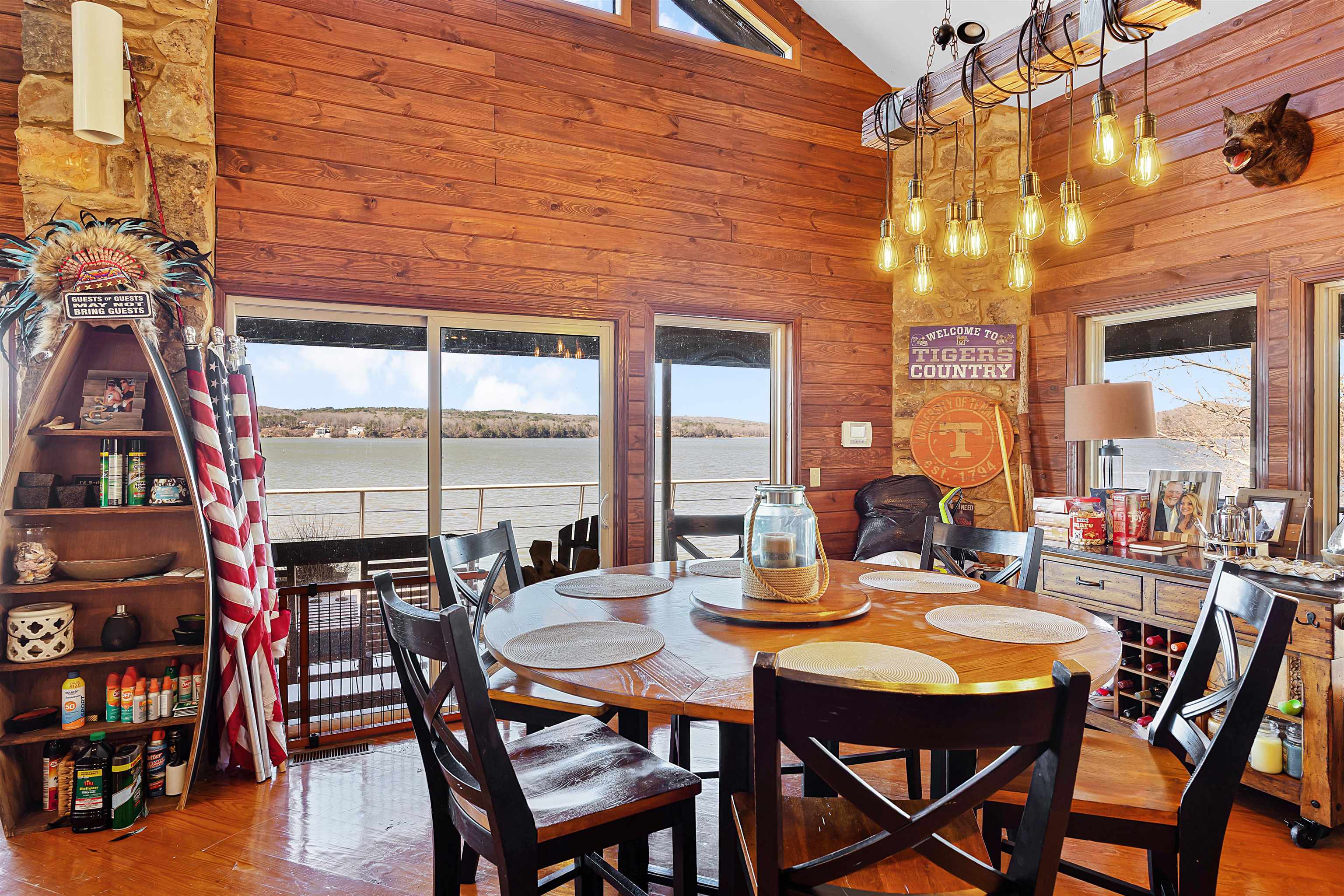 228 Chickasaw Trace Cherokee, AL 35616 - Photo 4 of 27 Dining space with high vaulted ceiling, a water view, wood finished floors, and wooden walls