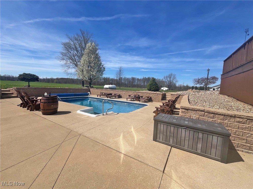 2159 Alliance Road Deerfield, OH 44411 - Photo 7 of 33 Outdoor pool featuring a patio area
