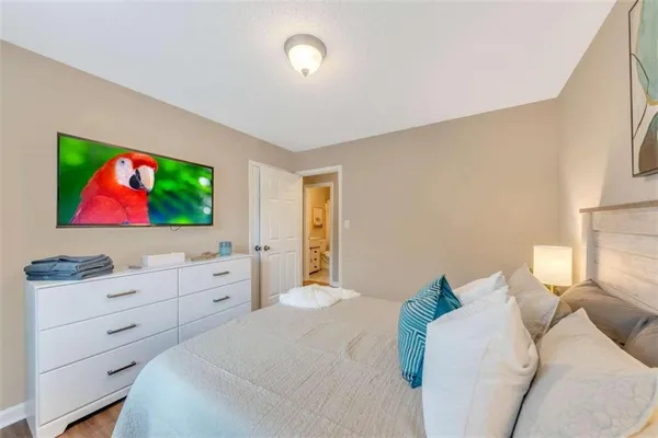 a bedroom with a bed and flat screen tv