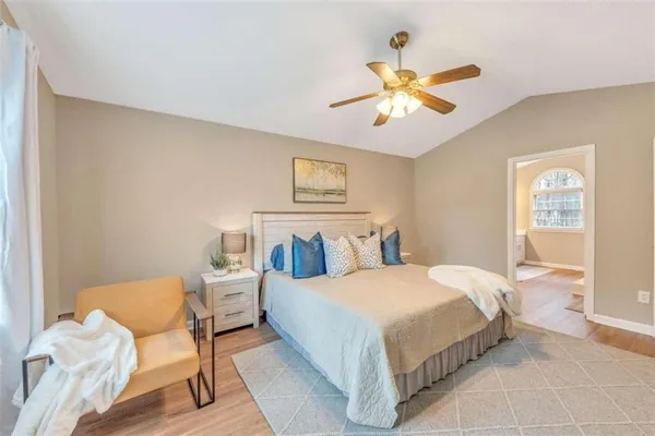 a bedroom with a bed and ceiling fan