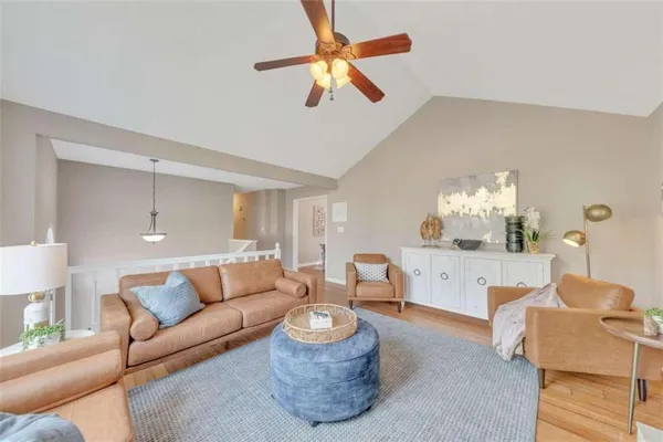 a living room with furniture and a chandelier