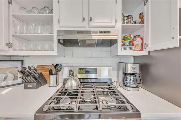 a kitchen with a stove and cabinets