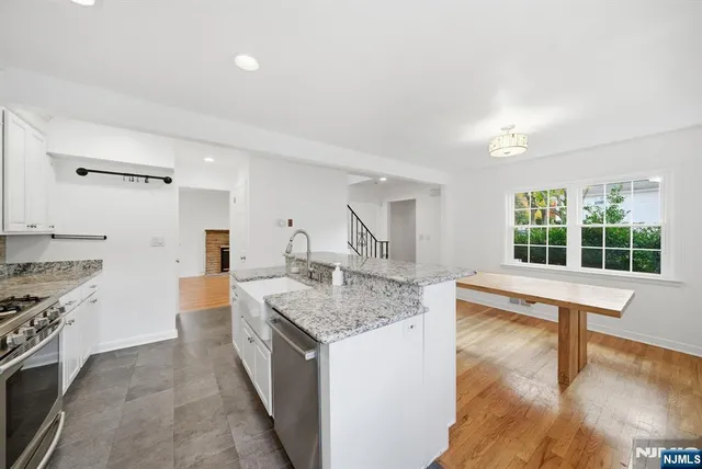 a open kitchen with a sink and a stove top oven