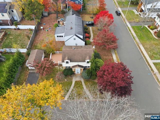 an aerial view of a house with a yard swimming pool and outdoor seating
