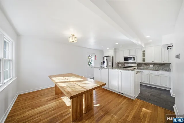 a kitchen with a sink cabinets and wooden floor