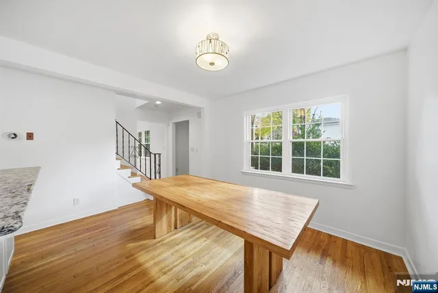 a view of a room with furniture and wooden floor