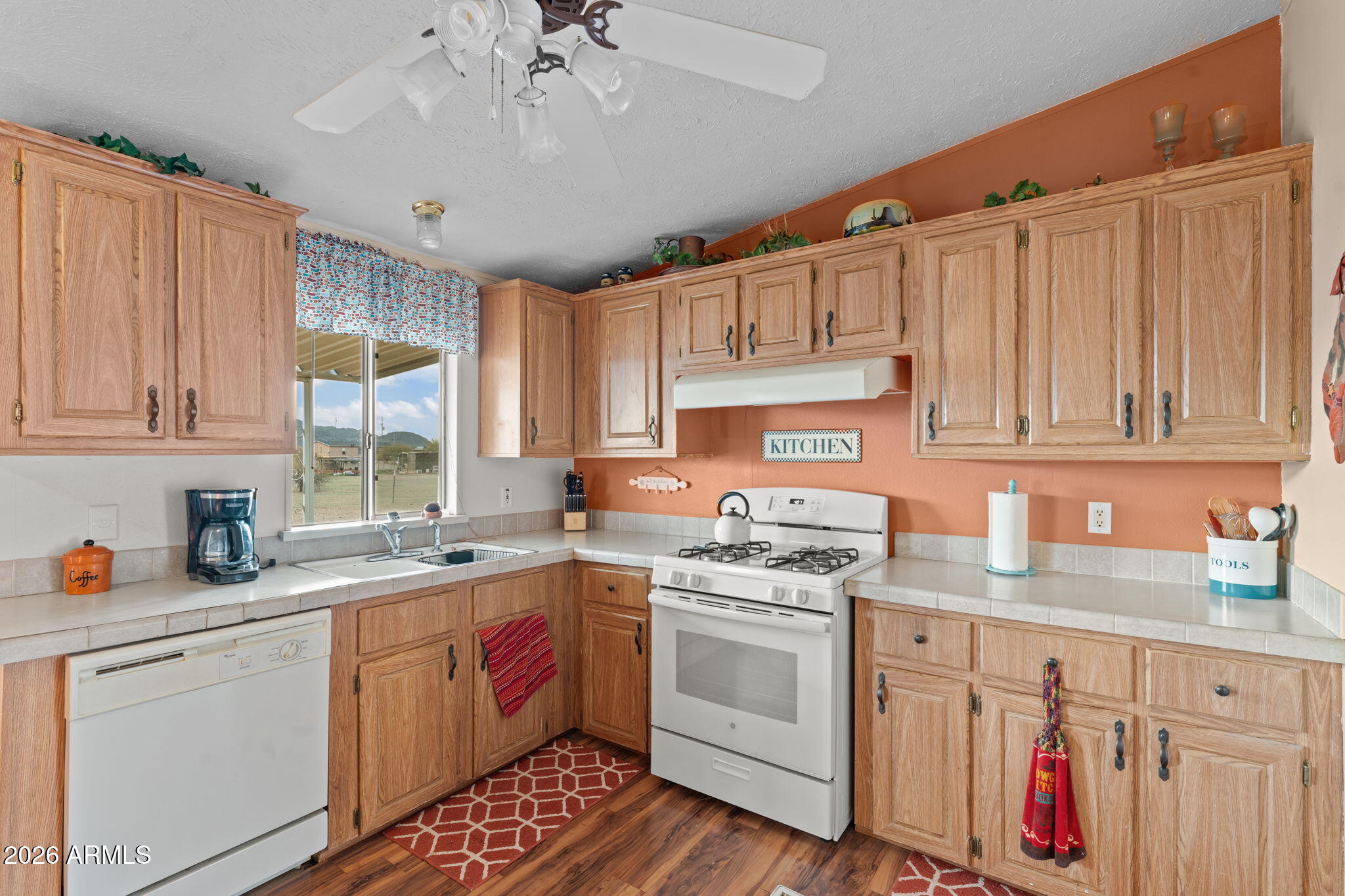 2817 Saddle Vista Road Tonopah, AZ 85354 - Photo 8 of 36 a kitchen with a sink stove and cabinets