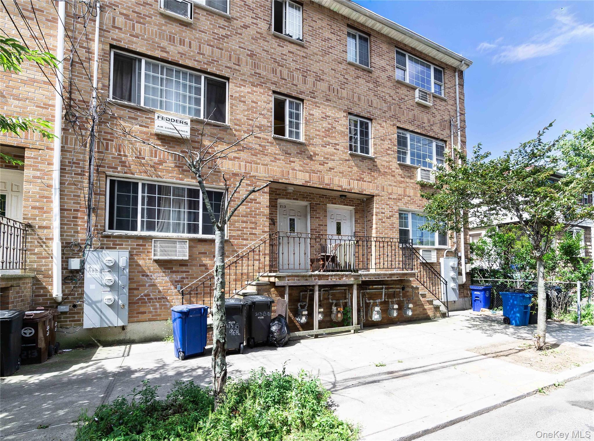 2-15 Beach 96th Street Queens, NY 11693 - Photo 1 of 39 a view of a brick house with potted plants and a table and chairs