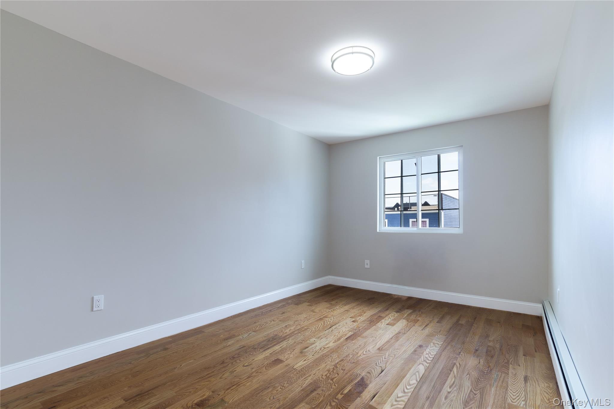 2-15 Beach 96th Street Queens, NY 11693 - Photo 12 of 39 wooden floor in an empty room with a window