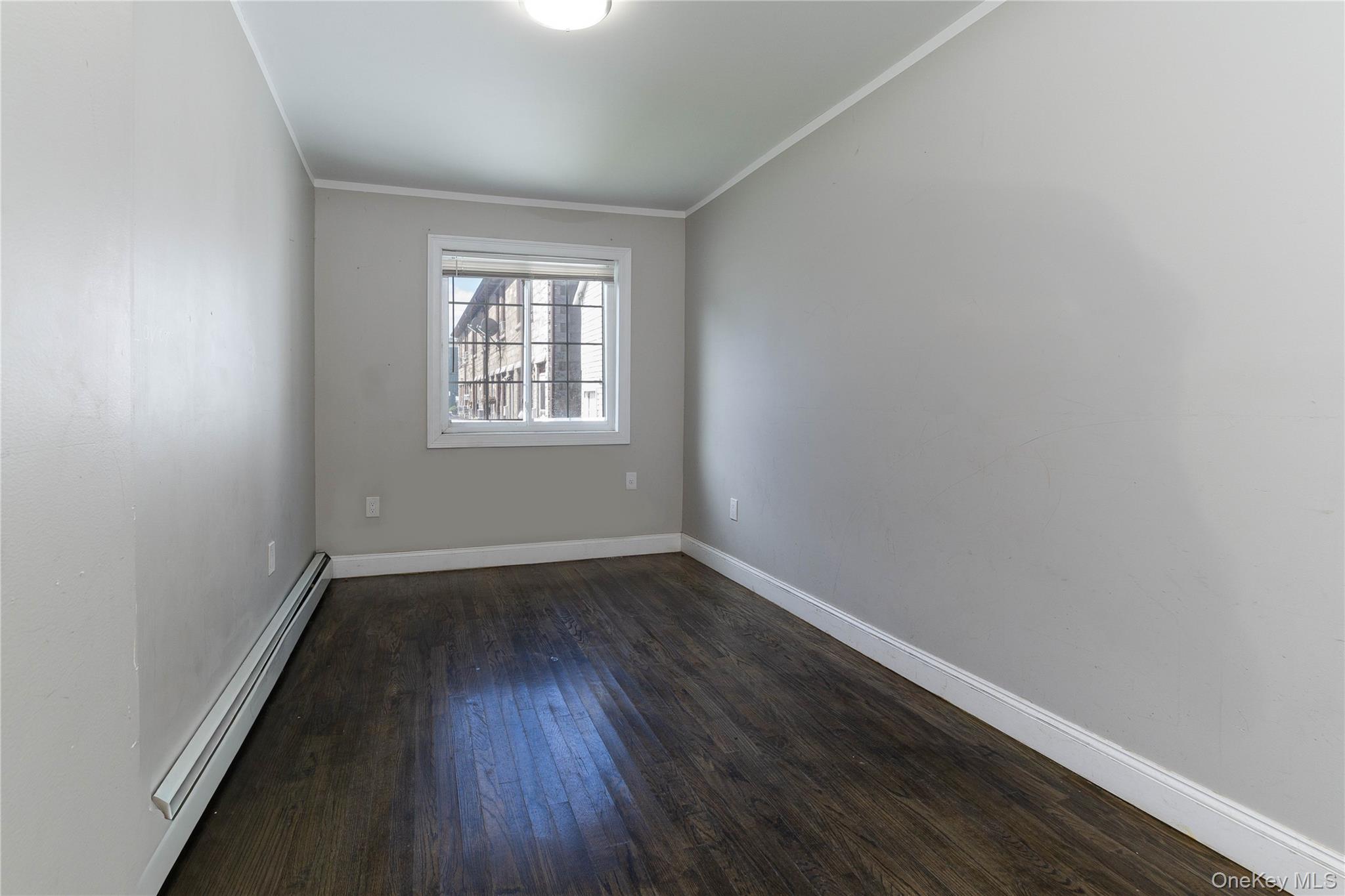 2-15 Beach 96th Street Queens, NY 11693 - Photo 19 of 39 an empty room with wooden floor and windows