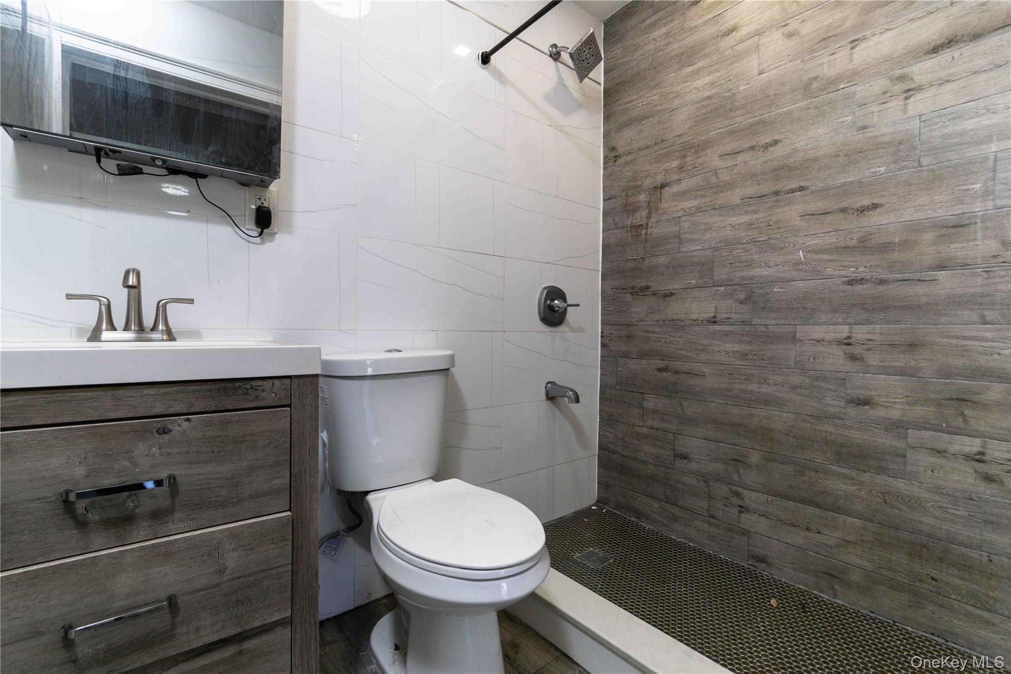 2-15 Beach 96th Street Queens, NY 11693 - Photo 23 of 39 a bathroom with a sink a toilet and shower