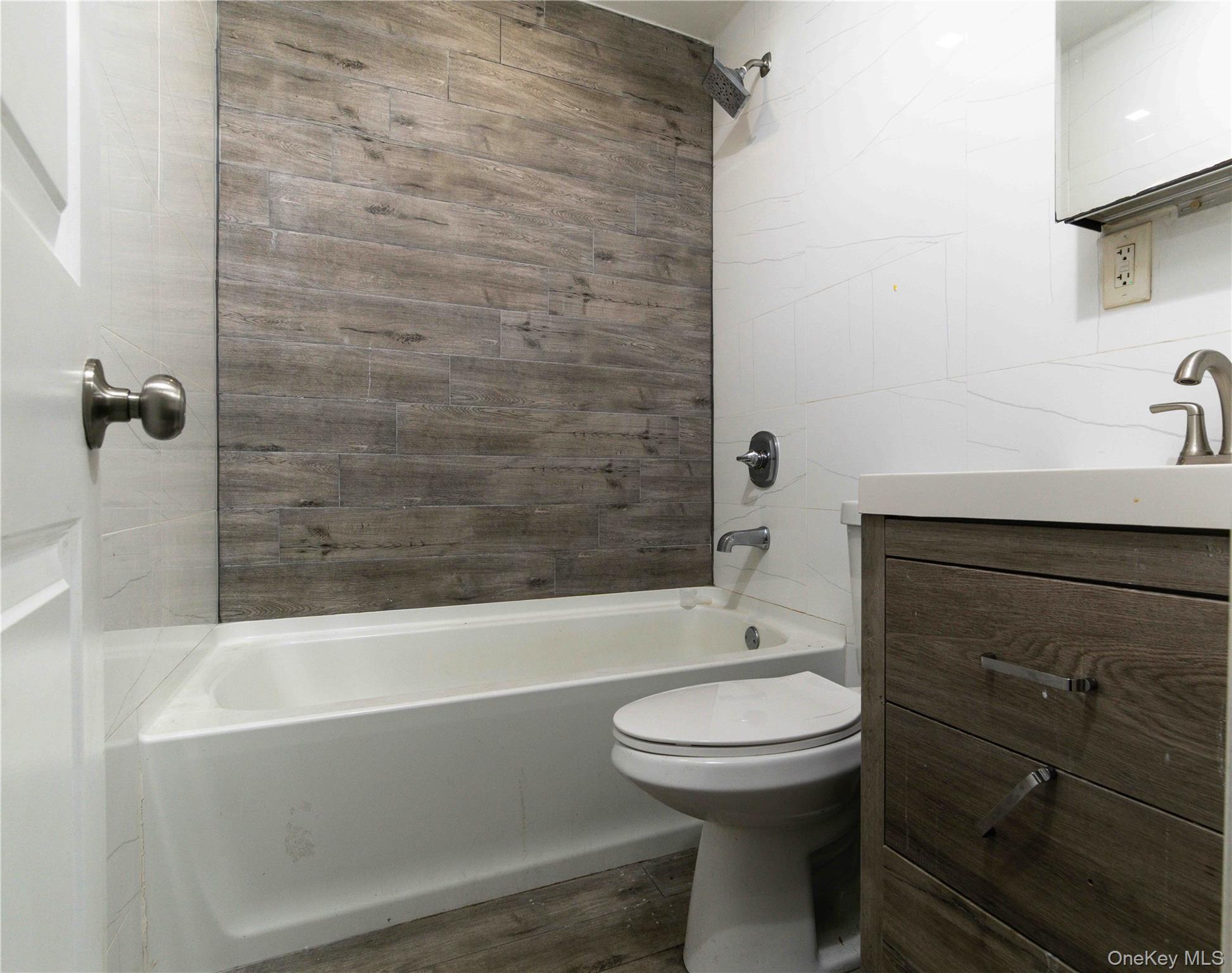 2-15 Beach 96th Street Queens, NY 11693 - Photo 24 of 39 a bathroom with a sink a toilet and bathtub