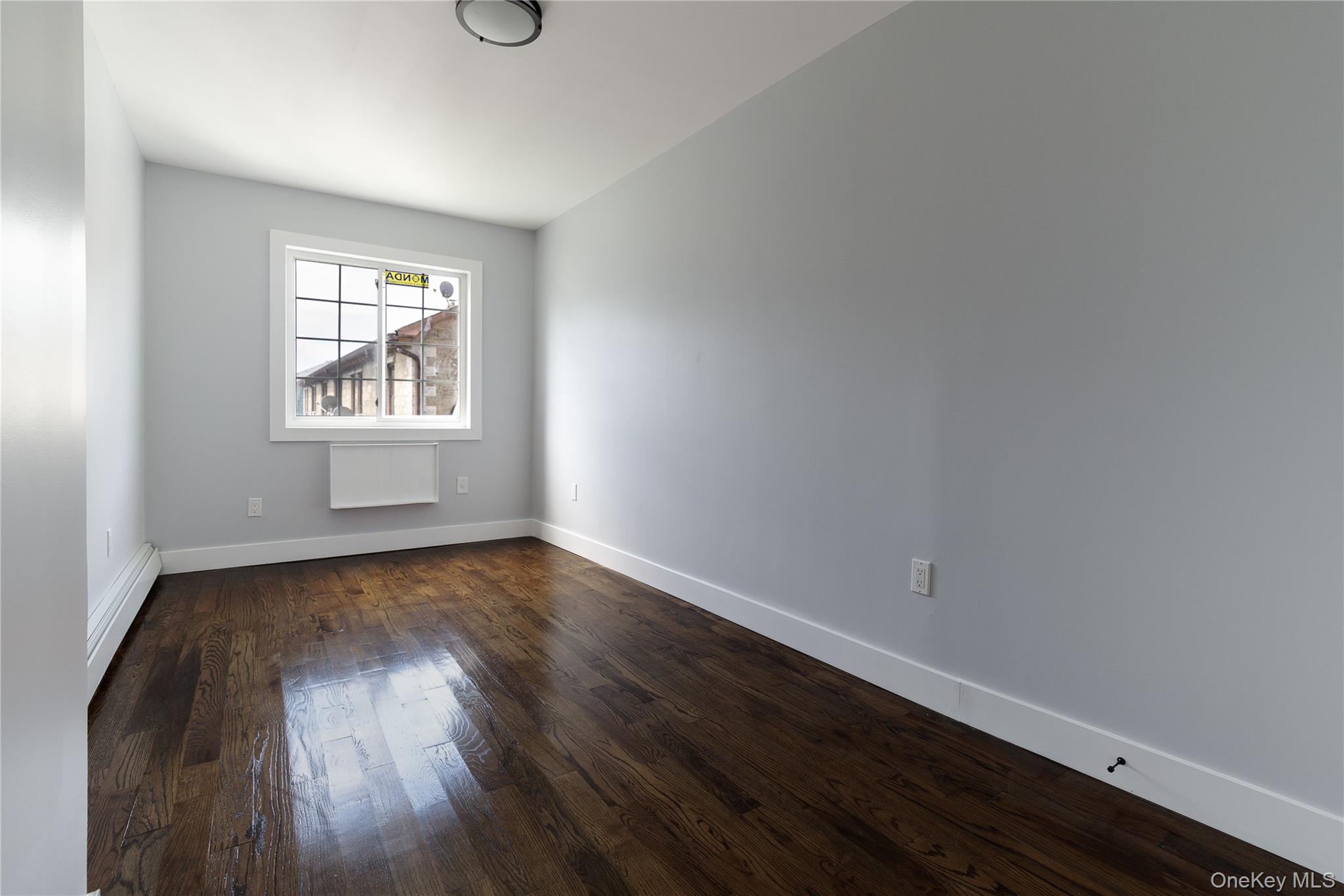 2-15 Beach 96th Street Queens, NY 11693 - Photo 34 of 39 an empty room with wooden floor and windows