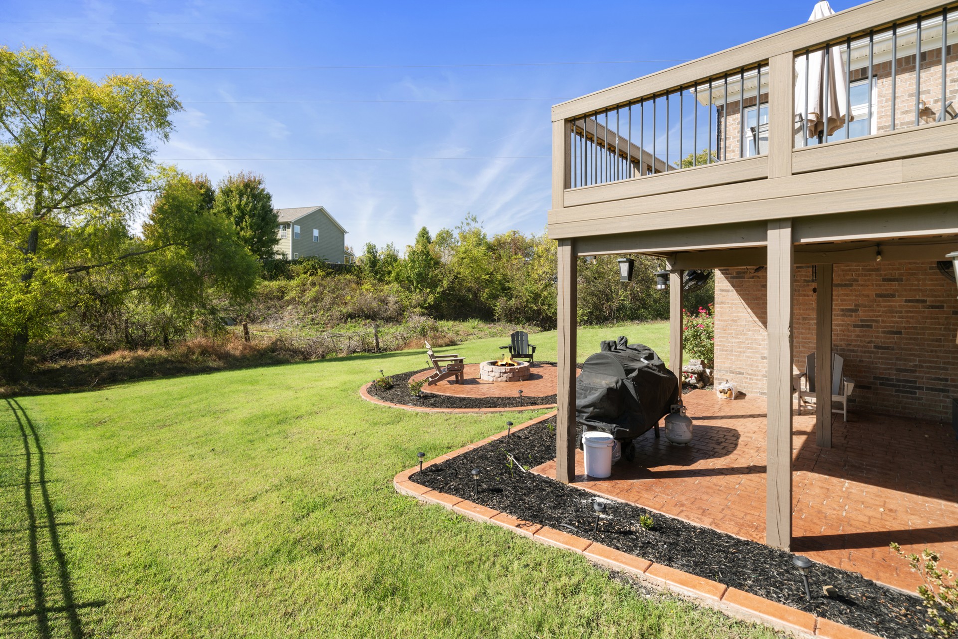 5000 Paddy Trace Spring Hill, TN 37174 - Photo 39 of 49 a view of a backyard with table and chairs potted plants and large tree