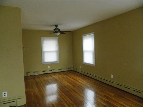 8 Girdler Road Marblehead, MA 01945 - Photo 3 of 12 an empty room with wooden floor and windows