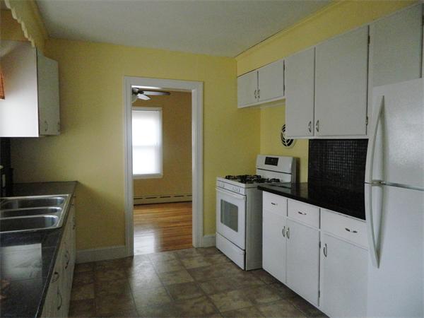 8 Girdler Road Marblehead, MA 01945 - Photo 4 of 12 a kitchen with granite countertop white cabinets and stainless steel appliances