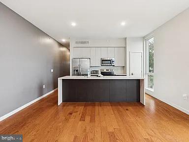 820 East Thompson Street, Unit E Philadelphia, PA 19125 - Photo 3 of 14 a kitchen with stainless steel appliances a refrigerator and a stove