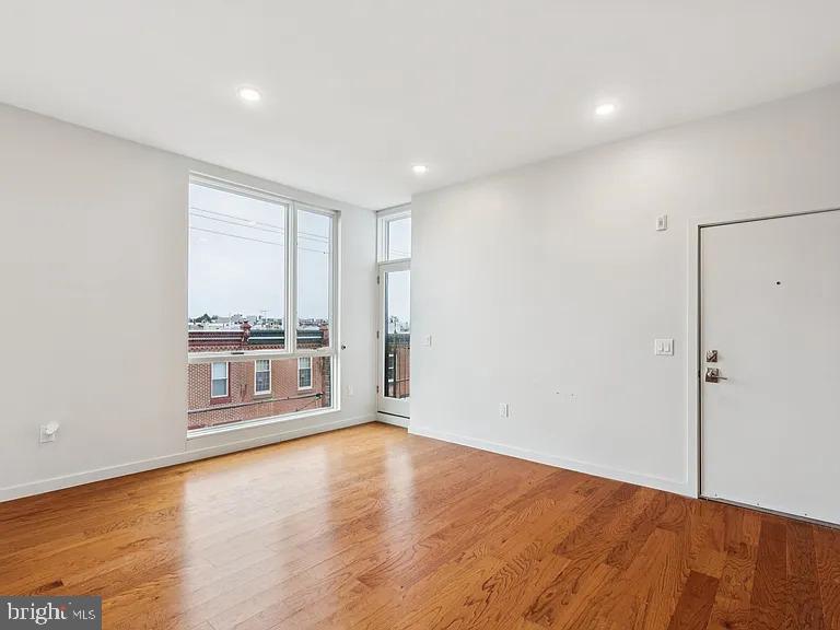 820 East Thompson Street, Unit E Philadelphia, PA 19125 - Photo 8 of 14 wooden floor in an empty room with a window