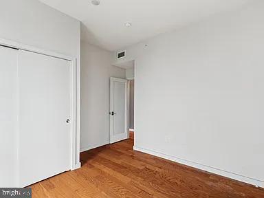 820 East Thompson Street, Unit E Philadelphia, PA 19125 - Photo 9 of 14 a view of an empty room with wooden floor and a window