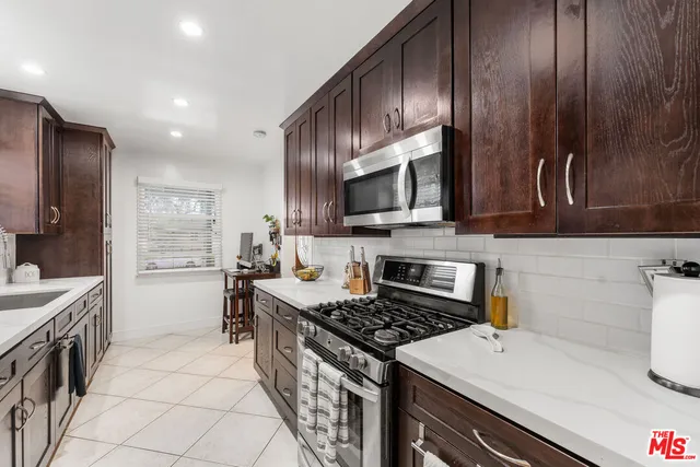 a kitchen with a sink stove and microwave