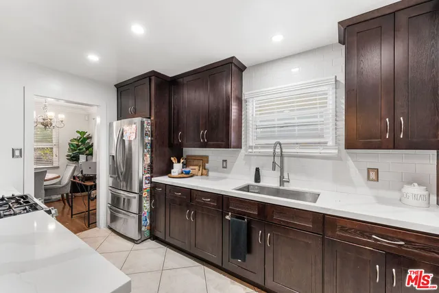 a kitchen with stainless steel appliances a sink stove and refrigerator