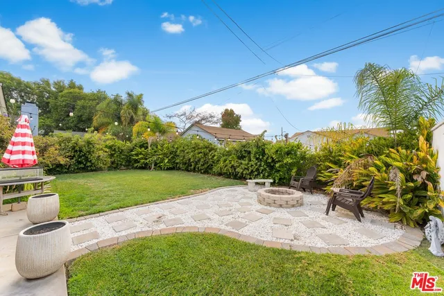 a view of a backyard with sitting area