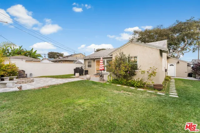 a view of a backyard with plants and a patio
