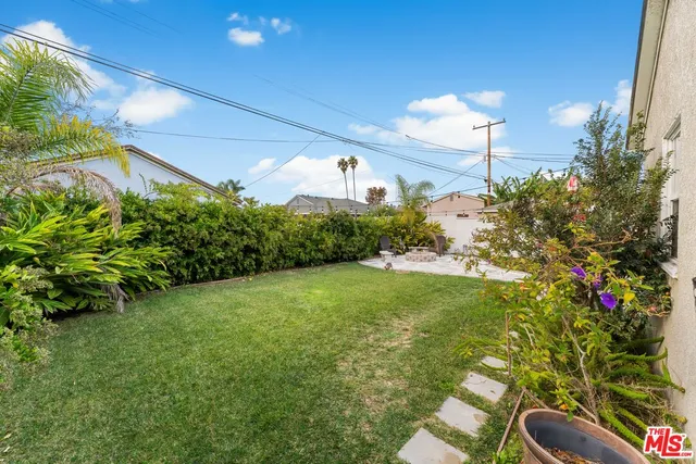 a flower garden is sitting in a backyard
