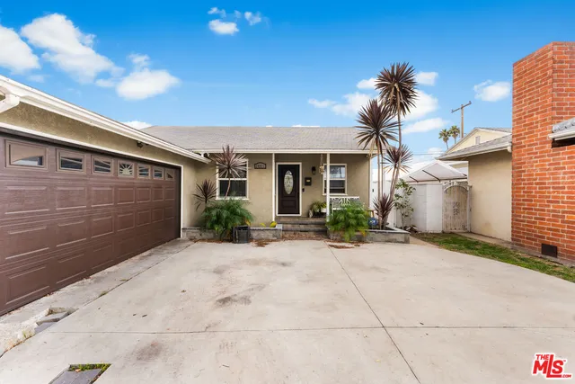 a view of house with garage and yard