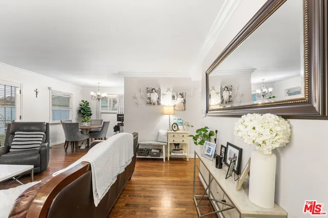 a living room with furniture and flowers