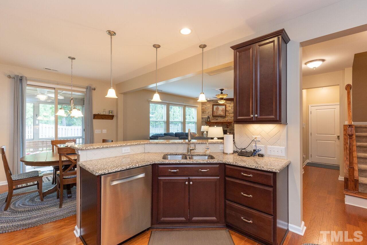 842 Wickham Ridge Road Apex, NC 27539 - Photo 11 of 43 a kitchen with a sink stove and cabinets