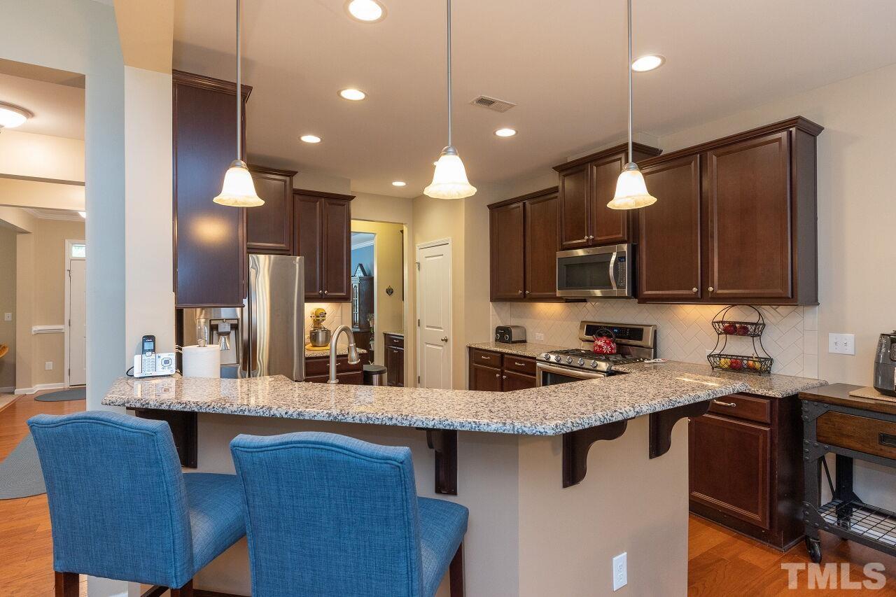 842 Wickham Ridge Road Apex, NC 27539 - Photo 13 of 43 a kitchen with a sink cabinets and window