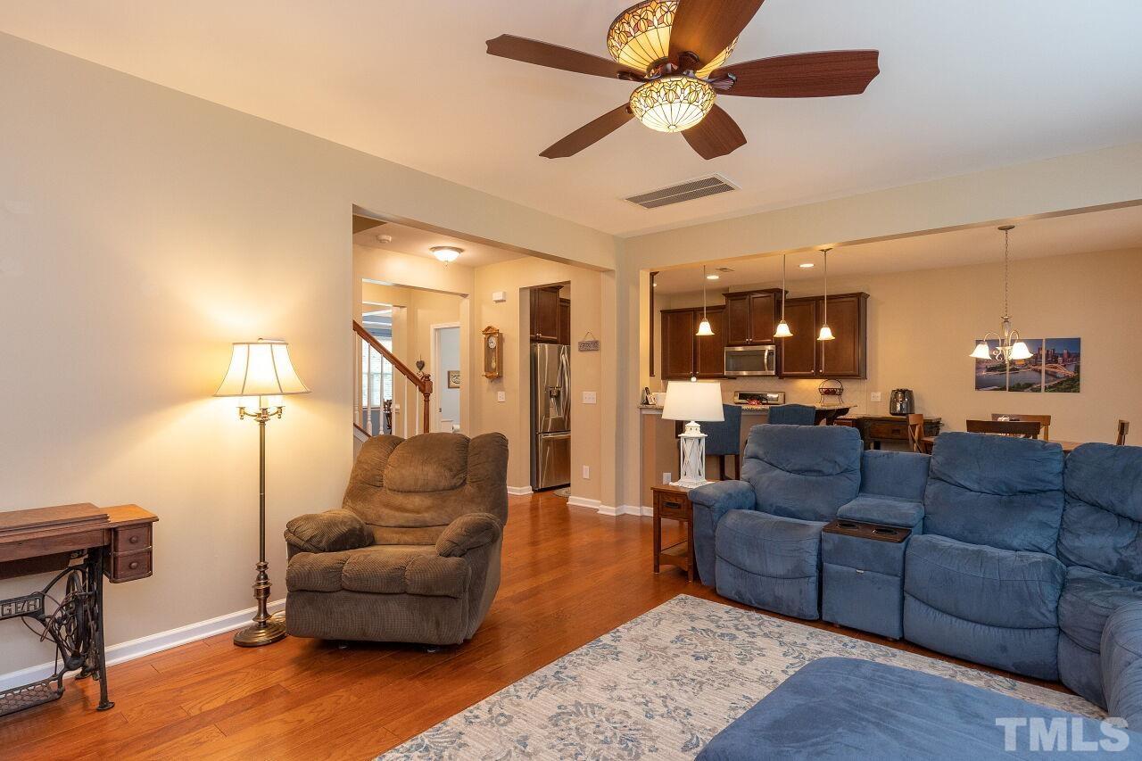 842 Wickham Ridge Road Apex, NC 27539 - Photo 17 of 43 a living room with furniture and a wooden floor