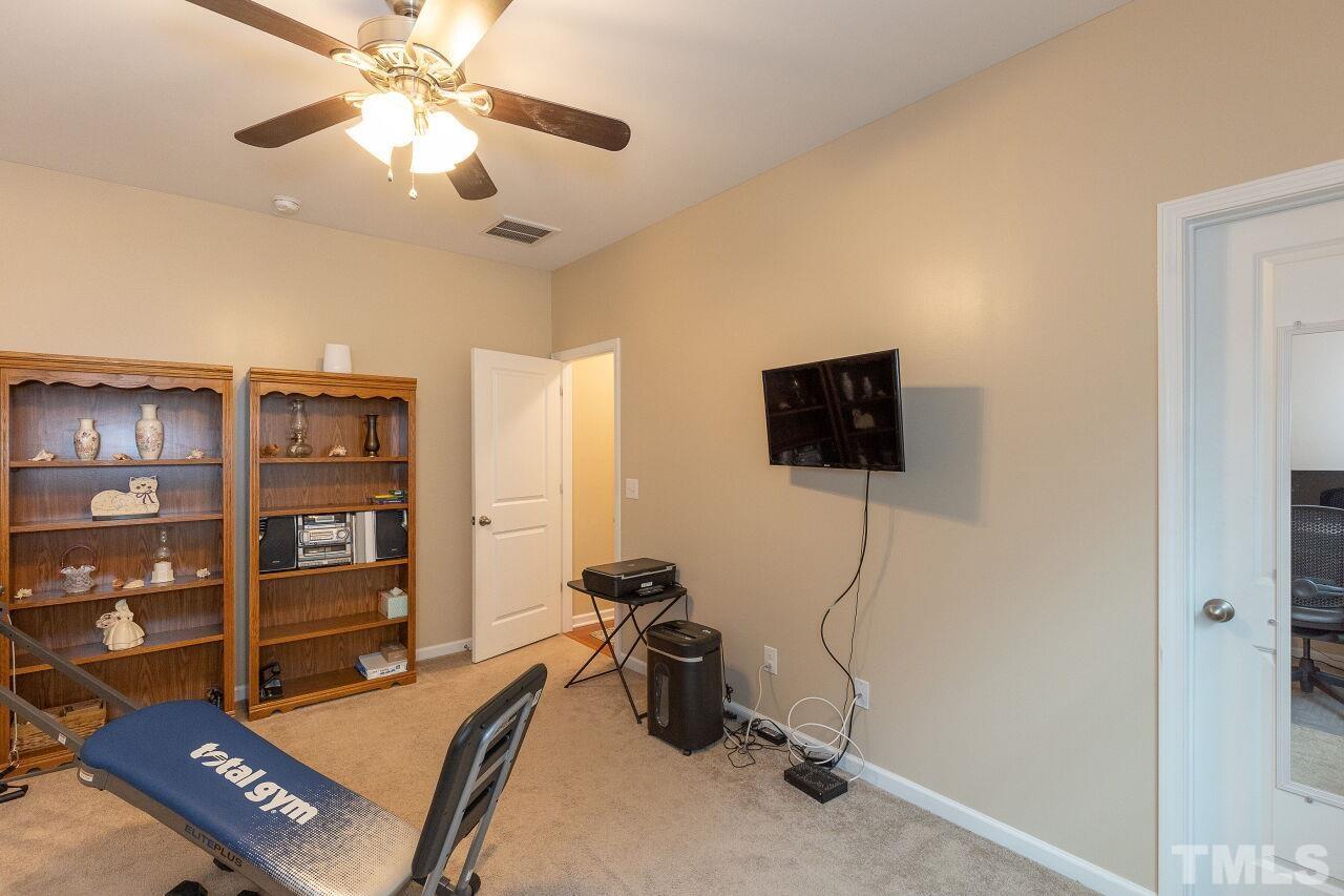 842 Wickham Ridge Road Apex, NC 27539 - Photo 19 of 43 a room with furniture and a flat screen tv