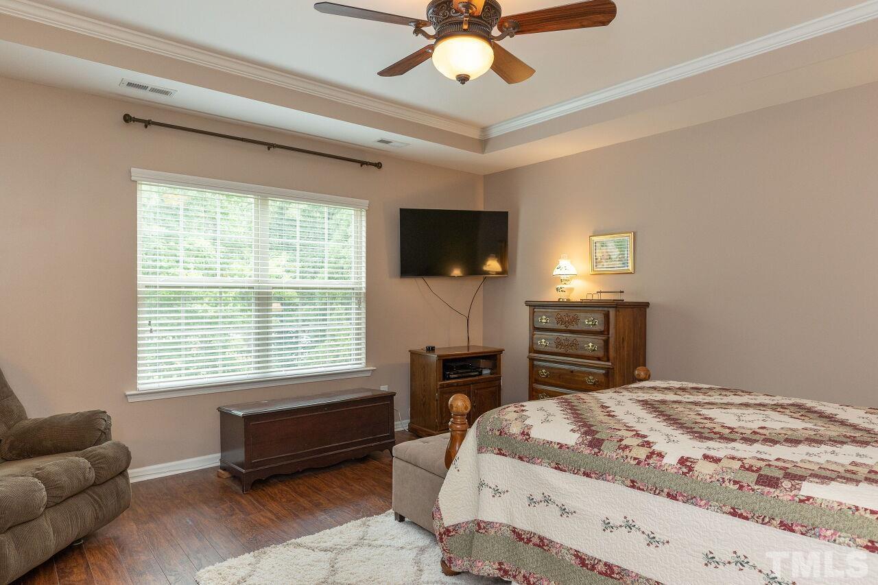 842 Wickham Ridge Road Apex, NC 27539 - Photo 21 of 43 a bedroom with a bed dresser and a window