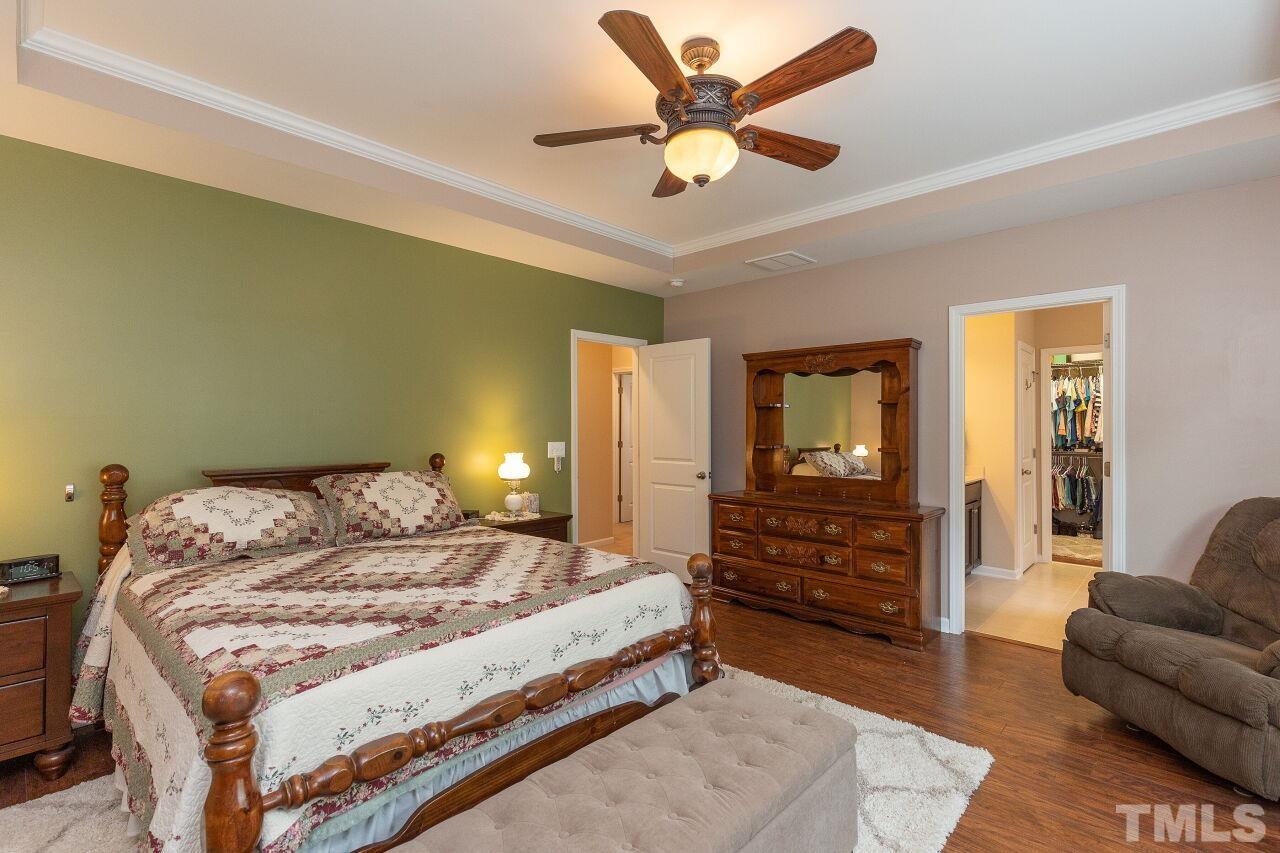 842 Wickham Ridge Road Apex, NC 27539 - Photo 22 of 43 a bedroom with a bed couch and dresser