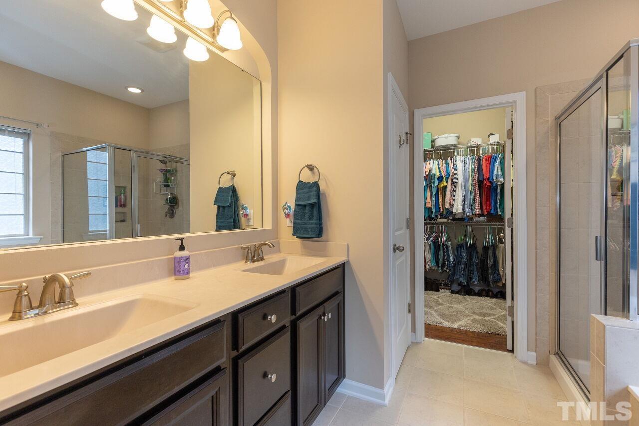 842 Wickham Ridge Road Apex, NC 27539 - Photo 24 of 43 a bathroom with a sink double vanity and a mirror