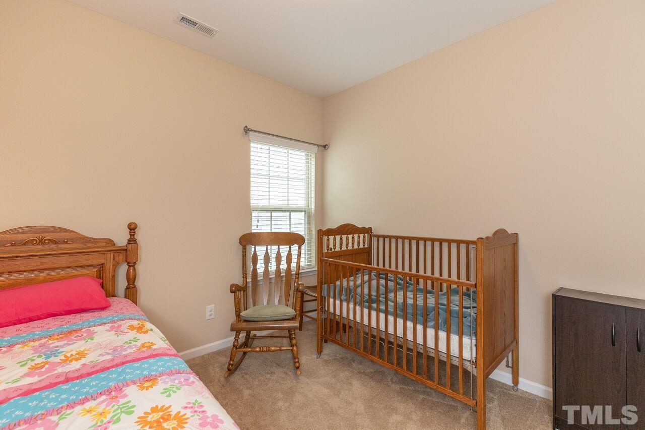 842 Wickham Ridge Road Apex, NC 27539 - Photo 28 of 43 a bedroom with a bed and a window