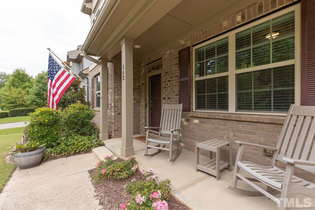 842 Wickham Ridge Road Apex, NC 27539 - Photo 3 of 43 a front view of a house with outdoor seating and plants