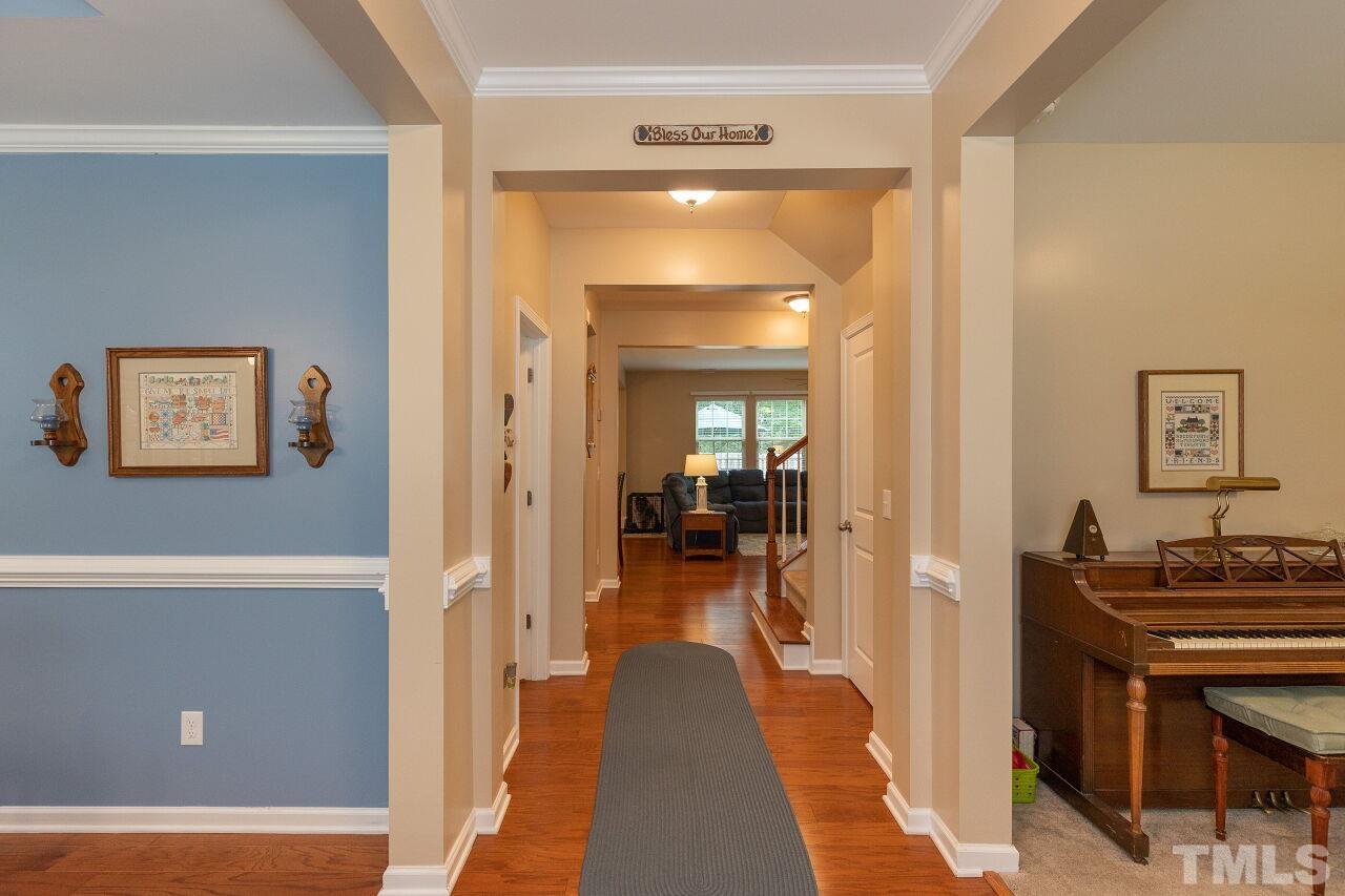 842 Wickham Ridge Road Apex, NC 27539 - Photo 4 of 43 a view of a hallway to a livingroom with furniture