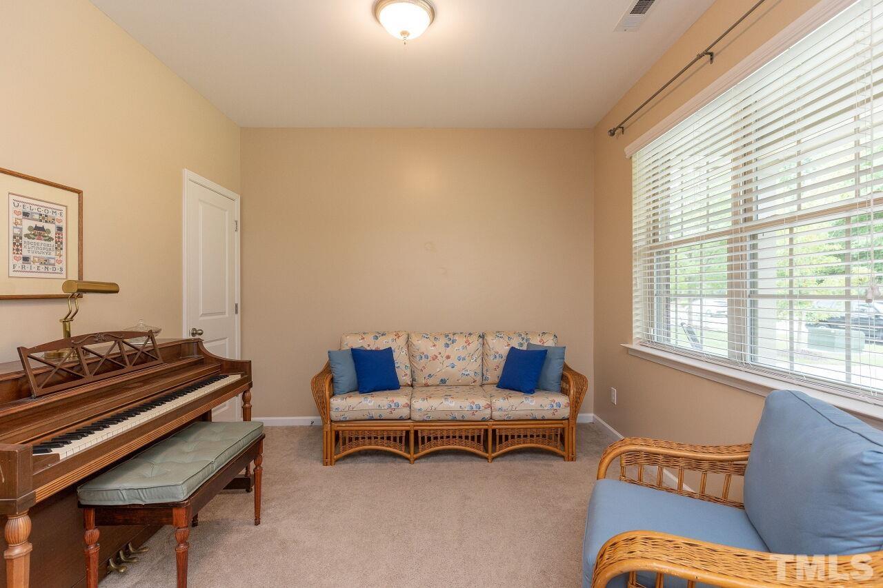 842 Wickham Ridge Road Apex, NC 27539 - Photo 6 of 43 a living room with furniture and a window