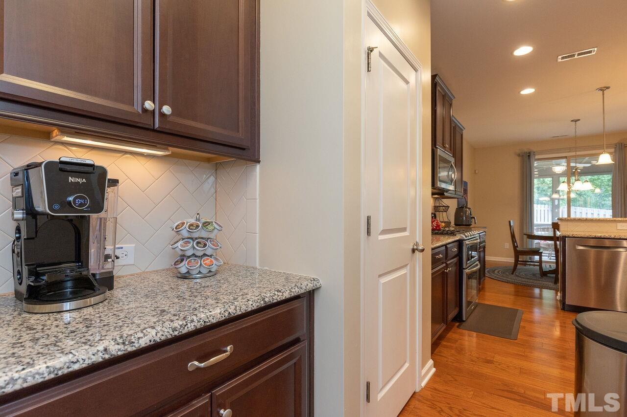 842 Wickham Ridge Road Apex, NC 27539 - Photo 10 of 43 a kitchen with counter top space cabinets and appliances