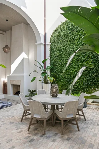 a view of a patio with table and chairs and potted plants