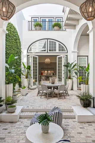 a view of a house with backyard sitting area and swimming pool
