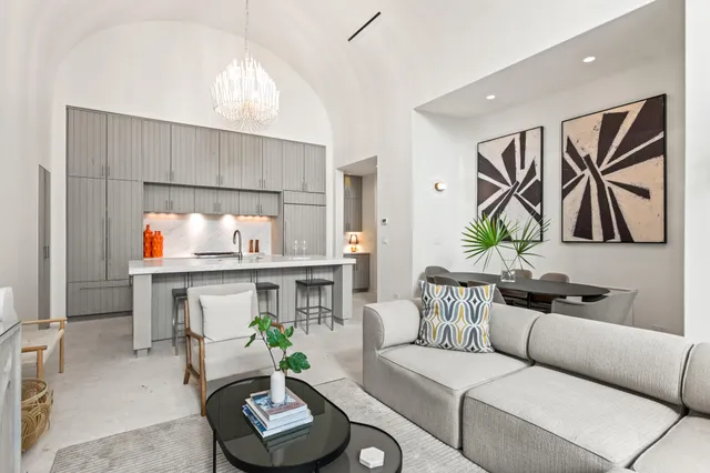 a living room with furniture and a floor to ceiling window