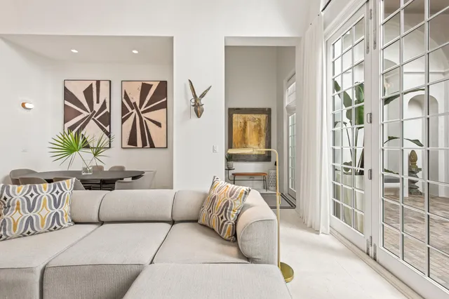 a kitchen with a kitchen island white cabinetry and chairs